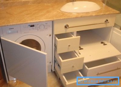 Amatöörikuva alkuperäisestä kaappista pesualtaan alla, johon kuuluu monien laatikoiden ja kodinkoneiden sijoittaminen